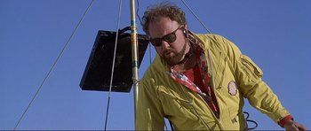 Movie still from “Dante's Peak” (1997), directed by Roger Donaldson – A man in a yellow jacket and headphones; Close Up shot, Low angle