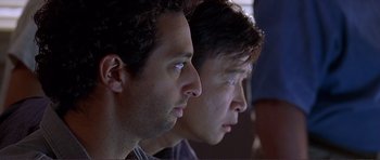 Movie still from “Dante's Peak” (1997), directed by Roger Donaldson – A couple of men sitting next to each other; Close Up shot, Low angle