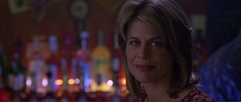 Movie still from “Dante's Peak” (1997), directed by Roger Donaldson – A woman's face in front of bottles; Close Up shot, Low angle