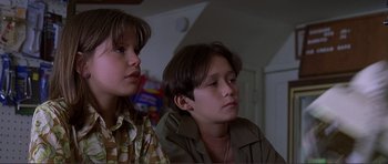 Movie still from “Dante's Peak” (1997), directed by Roger Donaldson – Two young boys sitting next to each other in a room; Close Up shot, Low angle
