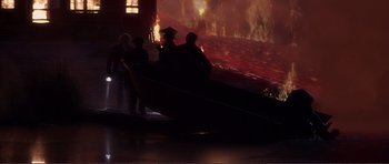 Movie still from “Dante's Peak” (1997), directed by Roger Donaldson – A group of people standing on a boat in a body of water; Extreme Wide shot, High angle