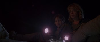 Movie still from “Dante's Peak” (1997), directed by Roger Donaldson – A boy and a girl are looking at lights; Medium shot, Low angle