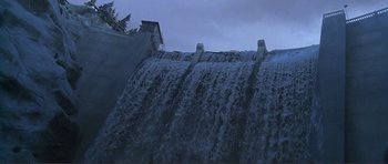Movie still from “Dante's Peak” (1997), directed by Roger Donaldson – A view of a waterfall from a boat on the water; Extreme Wide shot, Low angle