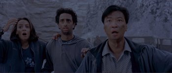 Movie still from “Dante's Peak” (1997), directed by Roger Donaldson – Two men standing next to each other in front of a stone wall; Close Up shot, Low angle