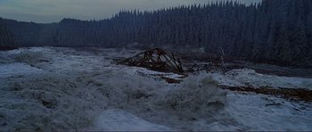 Movie still from “Dante's Peak” (1997), directed by Roger Donaldson – A large body of water surrounded by a forest; Extreme Wide shot, High angle