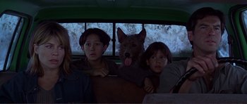Movie still from “Dante's Peak” (1997), directed by Roger Donaldson – Two people and a dog in the back of a bus; Close Up shot, Low angle
