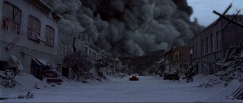 Movie still from “Dante's Peak” (1997), directed by Roger Donaldson – A car driving down a street in the middle of the night; Extreme Wide shot, High angle