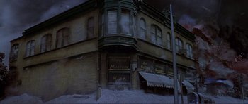 Movie still from “Dante's Peak” (1997), directed by Roger Donaldson – An old brick building with a lot of windows; Wide shot, High angle