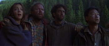 Movie still from “Dante's Peak” (1997), directed by Roger Donaldson – Two men standing next to each other near a forest; Medium shot, Low angle