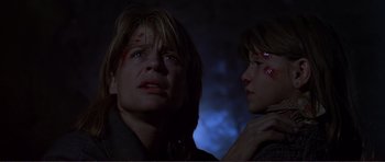 Movie still from “Dante's Peak” (1997), directed by Roger Donaldson – Two people are looking at each other in the dark; Close Up shot, Low angle
