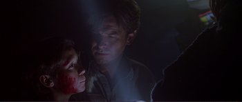 Movie still from “Dante's Peak” (1997), directed by Roger Donaldson – A man and a woman are looking at each other in the dark; Close Up shot, Over the shoulder angle
