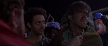 Movie still from “Dante's Peak” (1997), directed by Roger Donaldson – A group of men standing next to each other in a dark room; Close Up shot, Low angle