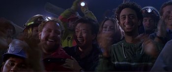 Movie still from “Dante's Peak” (1997), directed by Roger Donaldson – A group of people standing in a room with lights; Medium shot, Low angle