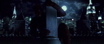 Movie still from “Daredevil” (2003), directed by Mark Steven Johnson – A man standing next to a pole in the dark; Wide shot, Low angle