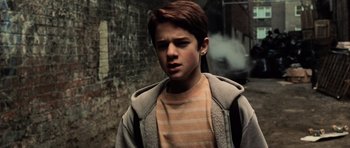 Movie still from “Daredevil” (2003), directed by Mark Steven Johnson – A young boy standing in front of a brick wall; Close Up shot, High angle