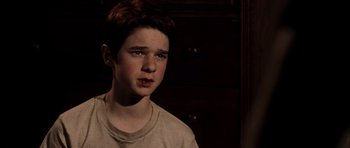 Movie still from “Daredevil” (2003), directed by Mark Steven Johnson – A young boy is looking at the camera; Close Up shot, High angle