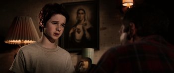 Movie still from “Daredevil” (2003), directed by Mark Steven Johnson – A young boy standing in front of a painting; Medium shot, Over the shoulder angle