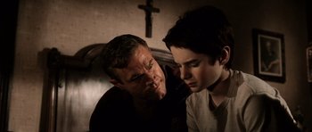 Movie still from “Daredevil” (2003), directed by Mark Steven Johnson – A man and a young boy looking at one another; Close Up shot, Over the shoulder angle