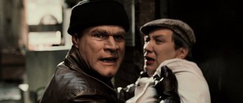 Movie still from “Daredevil” (2003), directed by Mark Steven Johnson – Two men are posing for a picture together; Close Up shot, Low angle