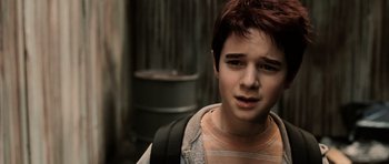 Movie still from “Daredevil” (2003), directed by Mark Steven Johnson – A boy with a backpack is looking at the camera; Close Up shot, High angle
