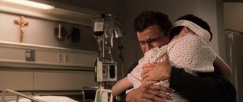 Movie still from “Daredevil” (2003), directed by Mark Steven Johnson – A man holding a baby in his arms in a hospital room; Close Up shot, Over the shoulder angle