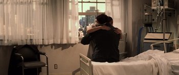 Movie still from “Daredevil” (2003), directed by Mark Steven Johnson – A man and a woman hugging in a hospital bed; Wide shot, High angle