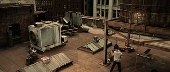 Movie still from “Daredevil” (2003), directed by Mark Steven Johnson – A man standing on top of a building near a crane; Extreme Wide shot, High angle