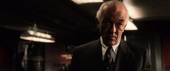 Movie still from “Daredevil” (2003), directed by Mark Steven Johnson – An older man wearing a suit and tie; Close Up shot, Low angle