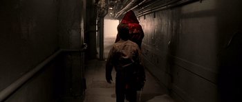 Movie still from “Daredevil” (2003), directed by Mark Steven Johnson – A man and a woman walking down a dark hallway; Wide shot, Over the shoulder angle