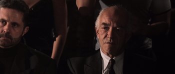 Movie still from “Daredevil” (2003), directed by Mark Steven Johnson – An older man wearing a suit and tie; Close Up shot, Low angle