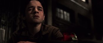 Movie still from “Daredevil” (2003), directed by Mark Steven Johnson – A young man with his eyes closed sitting in a dark room; Close Up shot, High angle