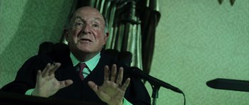 Movie still from “Daredevil” (2003), directed by Mark Steven Johnson – An older man wearing a suit and tie; Close Up shot, Low angle