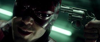 Movie still from “Daredevil” (2003), directed by Mark Steven Johnson – A person wearing a mask and holding a gun; Extreme Close Up shot, Overhead angle