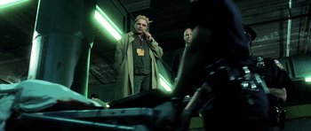 Movie still from “Daredevil” (2003), directed by Mark Steven Johnson – A man standing next to another man on a cell phone; Medium shot, Low angle