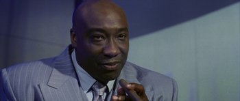 Movie still from “Daredevil” (2003), directed by Mark Steven Johnson – A person wearing a suit and tie; Close Up shot, Low angle