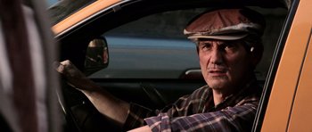 Movie still from “Daredevil” (2003), directed by Mark Steven Johnson – A man sitting in the driver's seat of a car; Close Up shot, Low angle