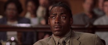 Movie still from “Daredevil” (2003), directed by Mark Steven Johnson – A man in a suit and tie looking at the camera; Close Up shot, Low angle