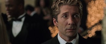 Movie still from “Daredevil” (2003), directed by Mark Steven Johnson – A person wearing a suit and tie; Close Up shot, Over the shoulder angle