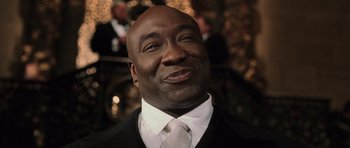 Movie still from “Daredevil” (2003), directed by Mark Steven Johnson – A person wearing a suit and a tie; Close Up shot, Low angle