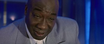 Movie still from “Daredevil” (2003), directed by Mark Steven Johnson – A person wearing a suit and tie; Close Up shot, Low angle