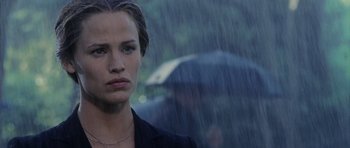 Movie still from “Daredevil” (2003), directed by Mark Steven Johnson – A person with a umbrella in the rain; Close Up shot, Over the shoulder angle
