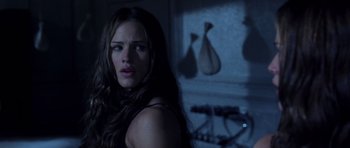 Movie still from “Daredevil” (2003), directed by Mark Steven Johnson – A beautiful woman with long brown hair standing in a room; Close Up shot, Over the shoulder angle