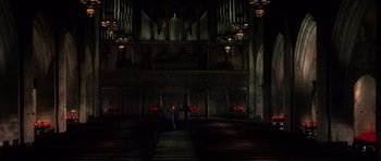 Movie still from “Daredevil” (2003), directed by Mark Steven Johnson – A man standing in front of an organ in a church; Extreme Wide shot, High angle