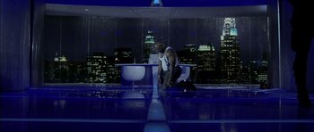 Movie still from “Daredevil” (2003), directed by Mark Steven Johnson – A man kneeling on the ground in front of a table; Wide shot, Low angle
