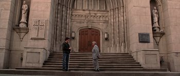 Movie still from “Daredevil” (2003), directed by Mark Steven Johnson – Two men standing on the steps of a church; Wide shot, High angle
