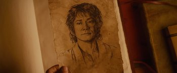 Movie still from “The Hobbit: An Unexpected Journey” (2012), directed by Peter Jackson – A drawing of a man with long brown hair; Extreme Close Up shot, Overhead angle