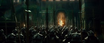 Movie still from “The Hobbit: An Unexpected Journey” (2012), directed by Peter Jackson – A bunch of people are standing in front of a door; Wide shot, High angle