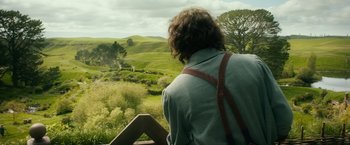 Movie still from “The Hobbit: An Unexpected Journey” (2012), directed by Peter Jackson – A man looking out over a green valley; Wide shot, Over the shoulder angle
