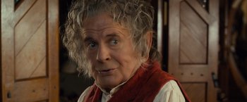 Movie still from “The Hobbit: An Unexpected Journey” (2012), directed by Peter Jackson – An older man with a surprised look on his face; Close Up shot, Over the shoulder angle