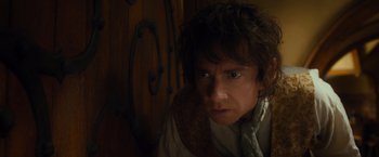 Movie still from “The Hobbit: An Unexpected Journey” (2012), directed by Peter Jackson – A man in a white shirt is looking at the camera; Close Up shot, High angle